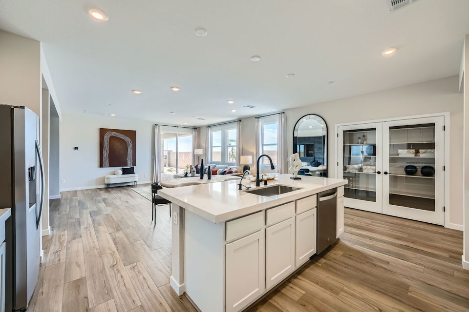 A kitchen with white cabinets.