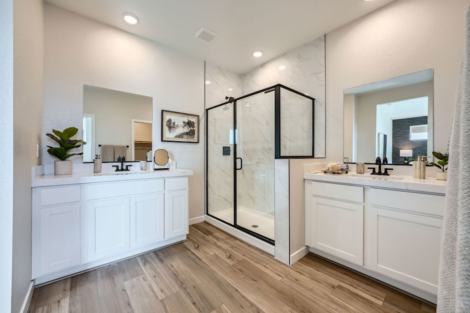 A bathroom with white cabinets.