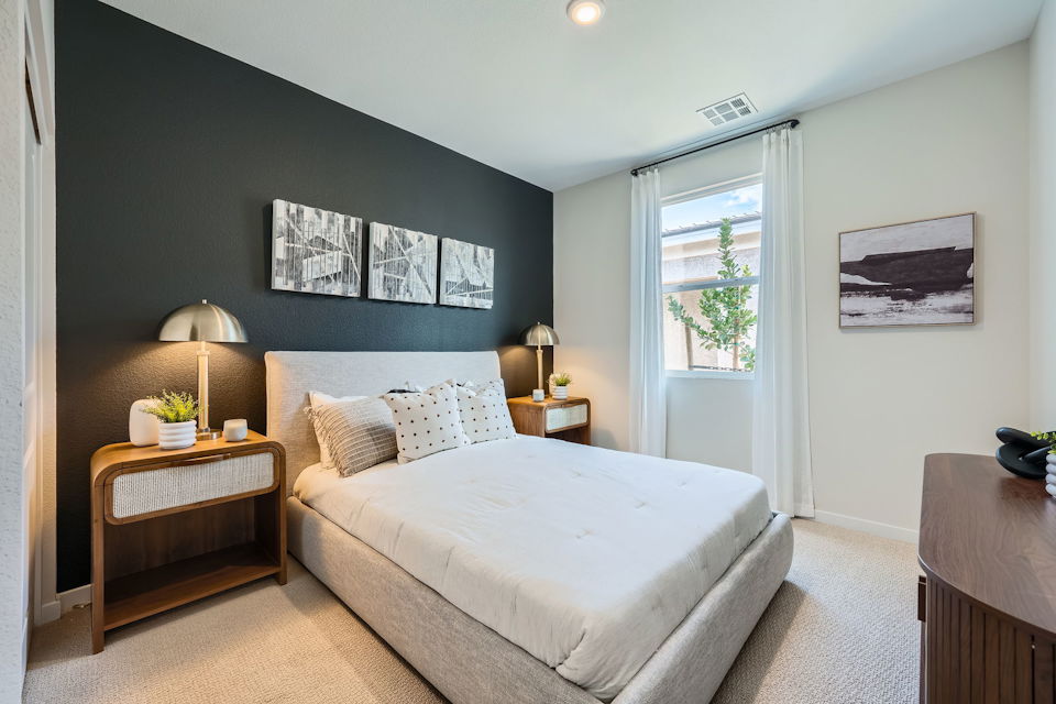 A bedroom with a bed and a desk.