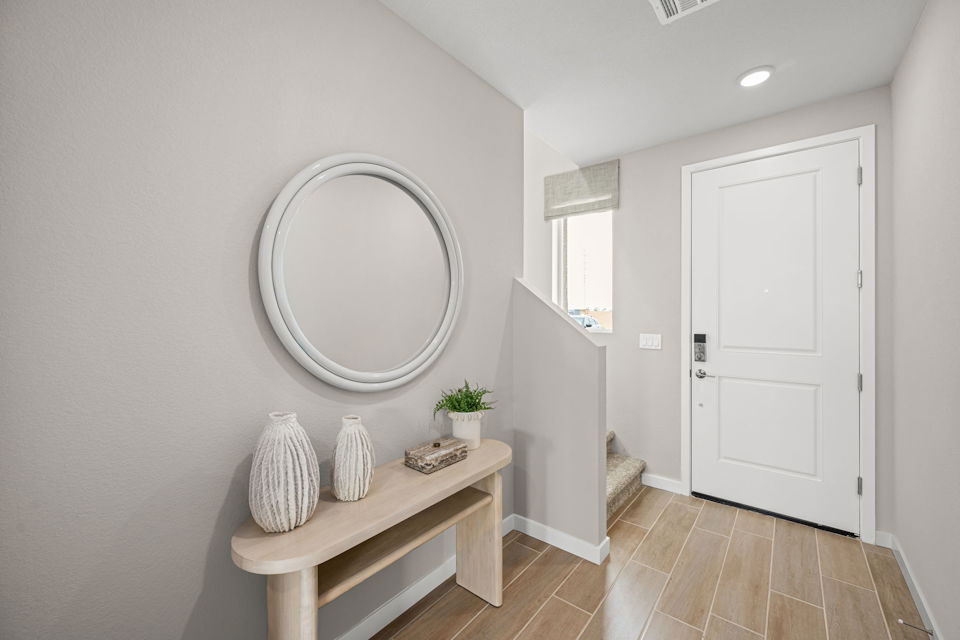 A room with a mirror and a table.