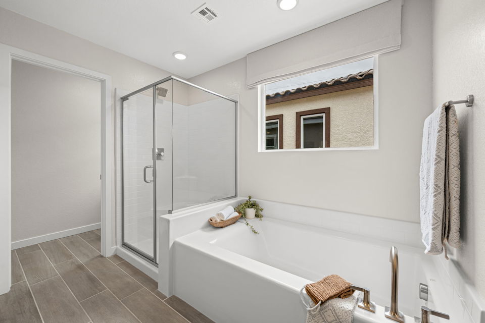 A bathroom with a tub and shower.