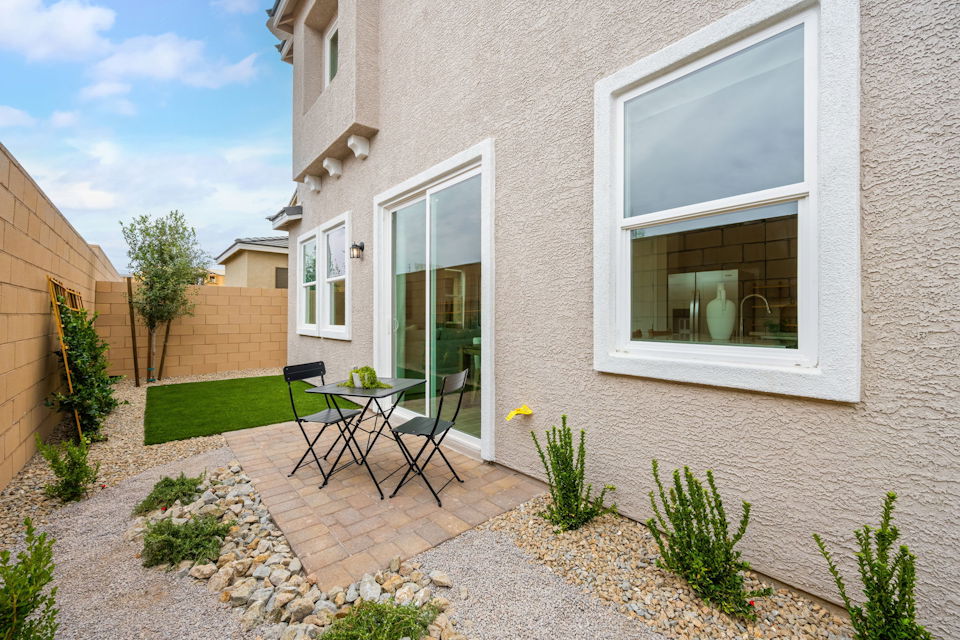 A patio with a table and chairs.