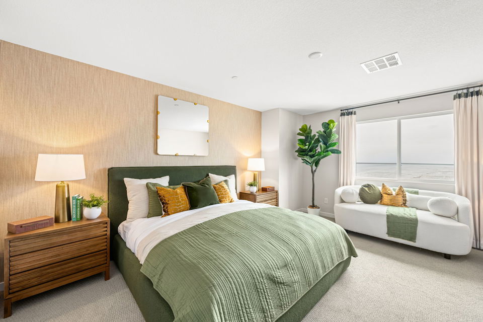 A bedroom with a bed and a couch.