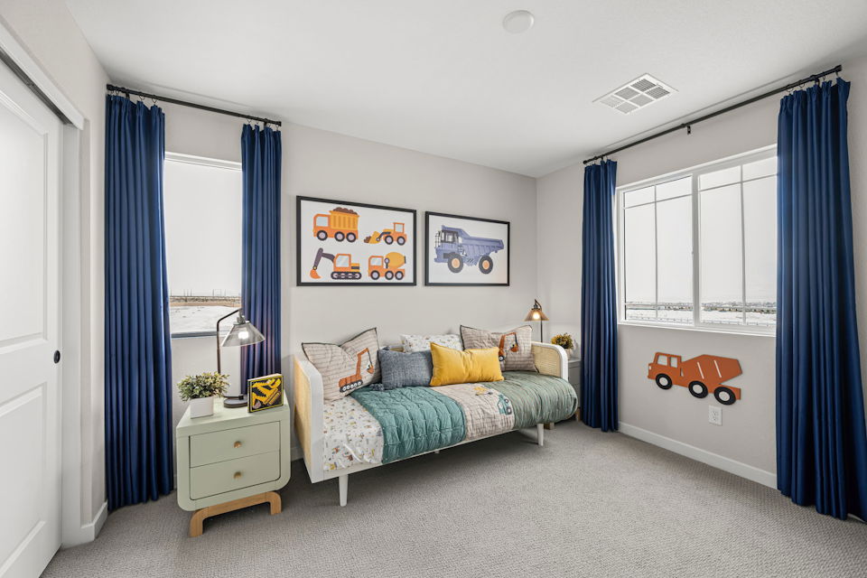 A bedroom with a bed and a guitar on the wall.