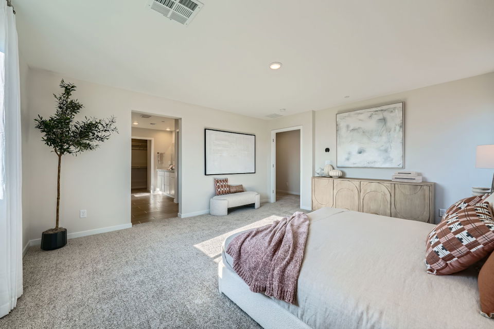 A bedroom with a bed and a couch.