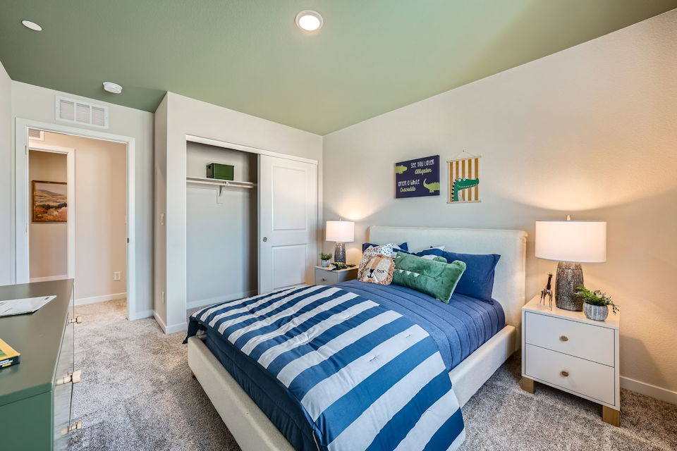 A bedroom with a bed and a desk.