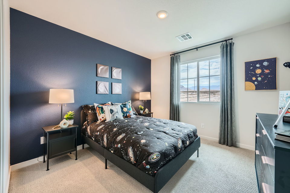 A bedroom with a bed and a desk.