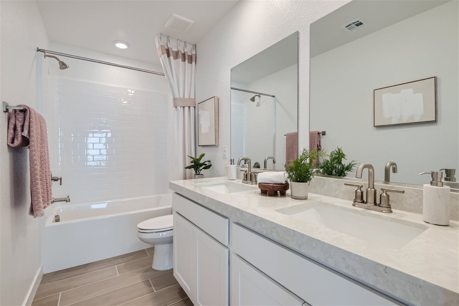 A bathroom with a tub sink and toilet.