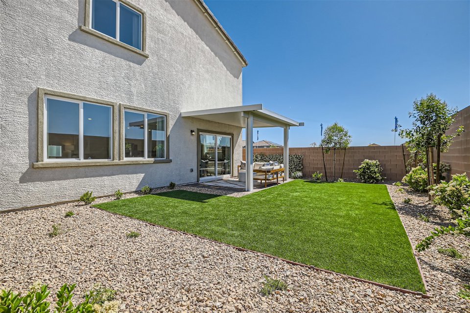 A house with a yard and a fence.