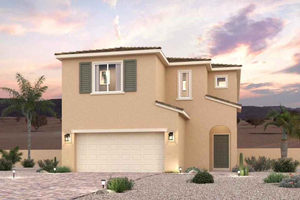 A house with a garage and palm trees.