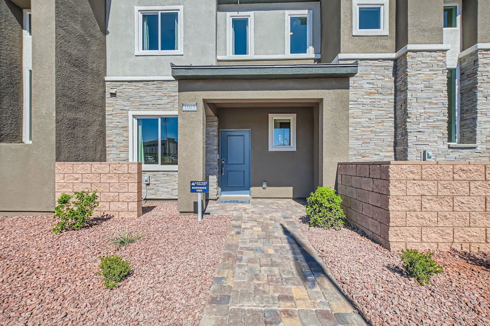 A brick building with a blue door.