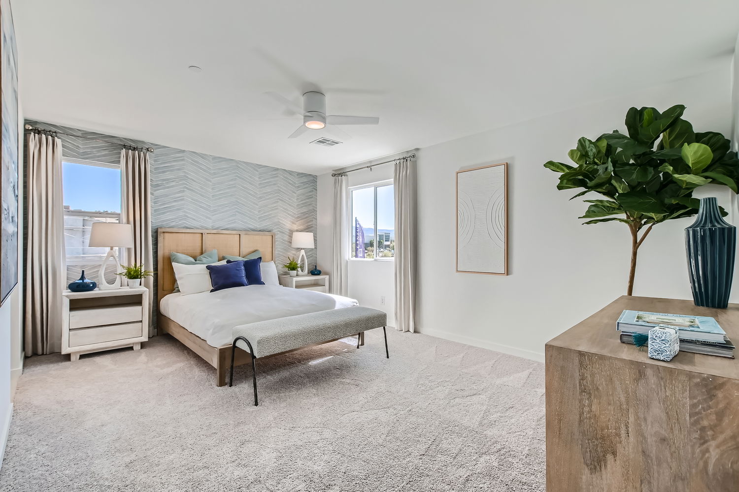 A bedroom with a bed and a table.