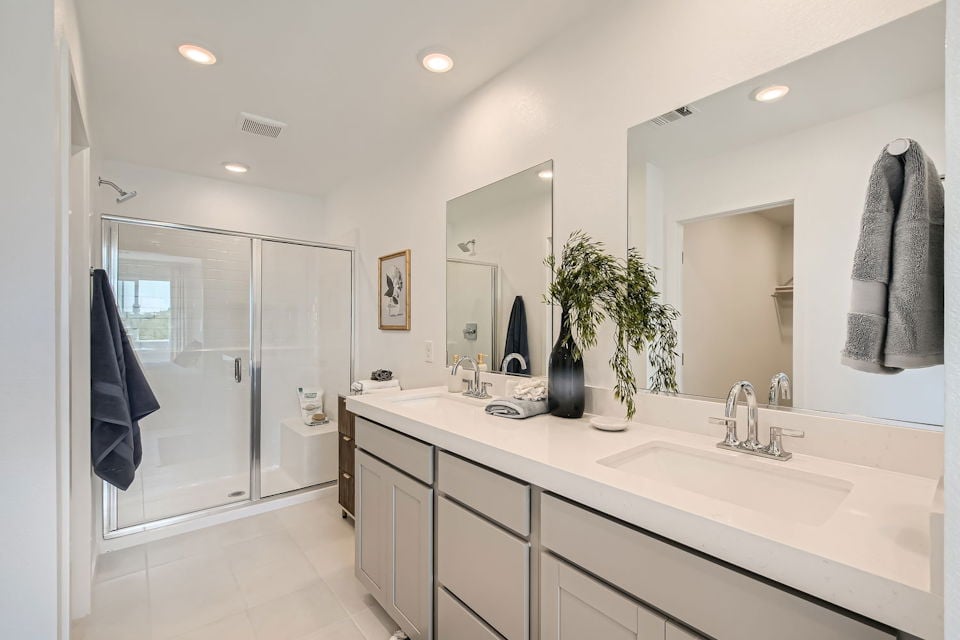 A bathroom with a large mirror.