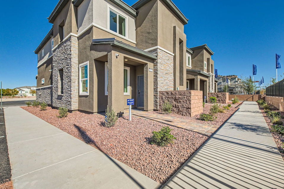 A stone building with a brick walkway.