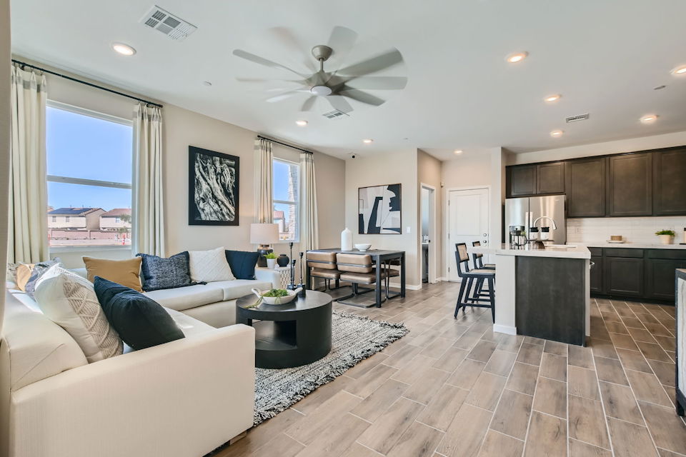 A living room with a large kitchen.