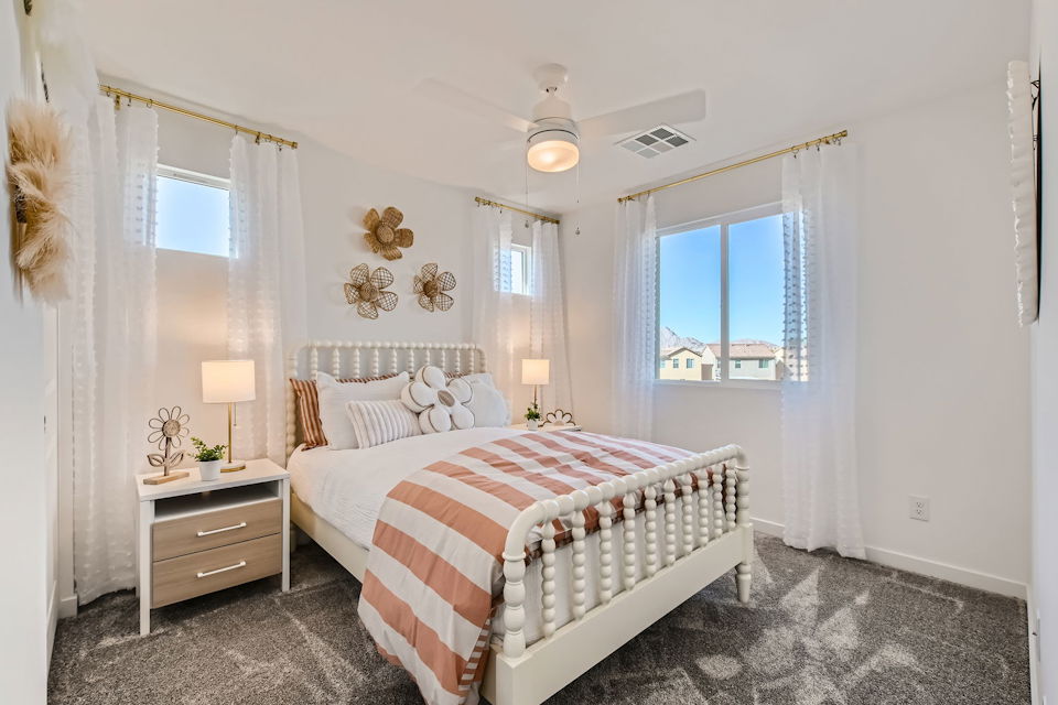 A bedroom with a bed and a window.