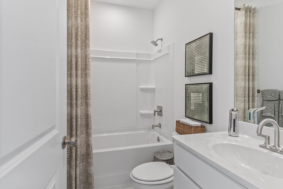 A bathroom with a tub sink and toilet.