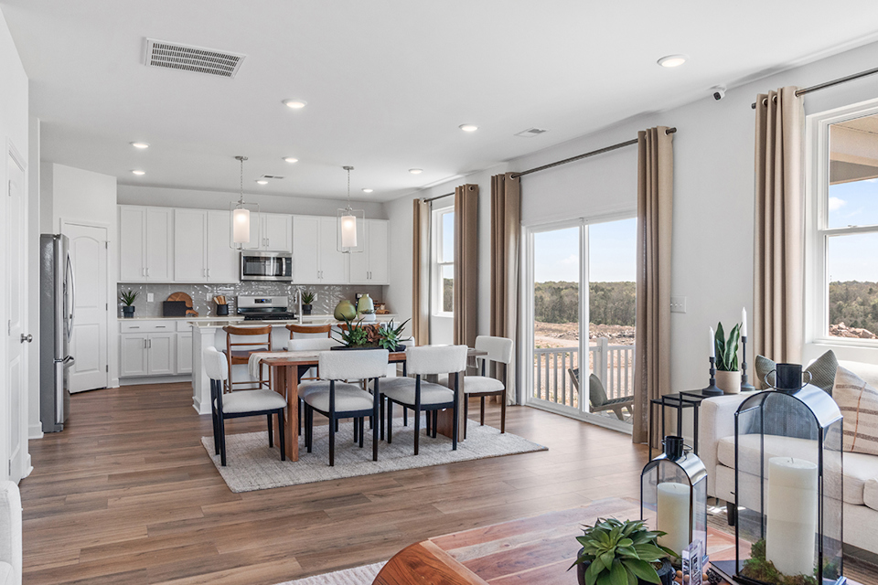 A kitchen with a dining table and chairs.