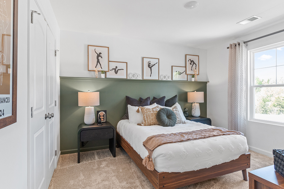 A bedroom with a bed and lamps.