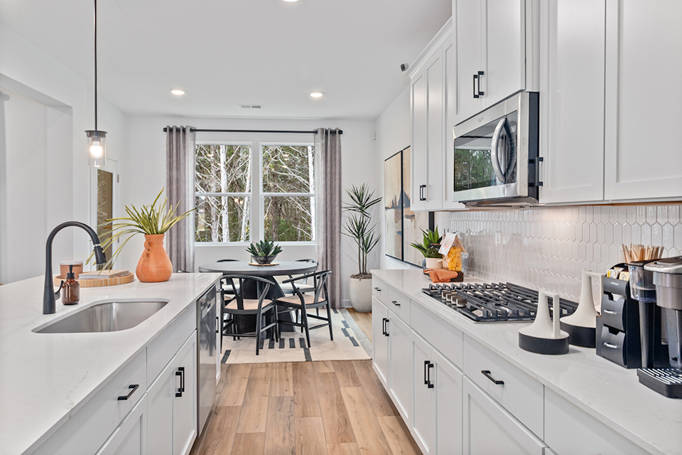 A kitchen with white cabinets.