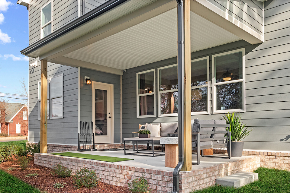 A house with a patio and a table and chairs.