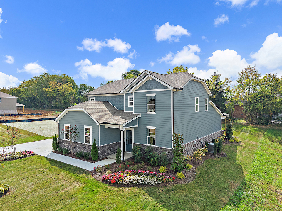A house with a garden in the front.