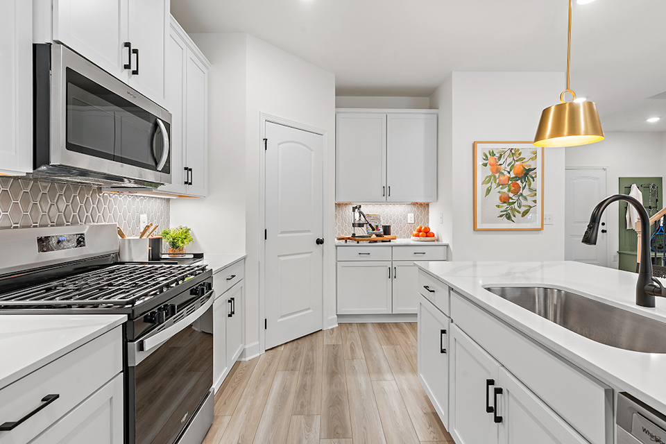 A kitchen with white cabinets.