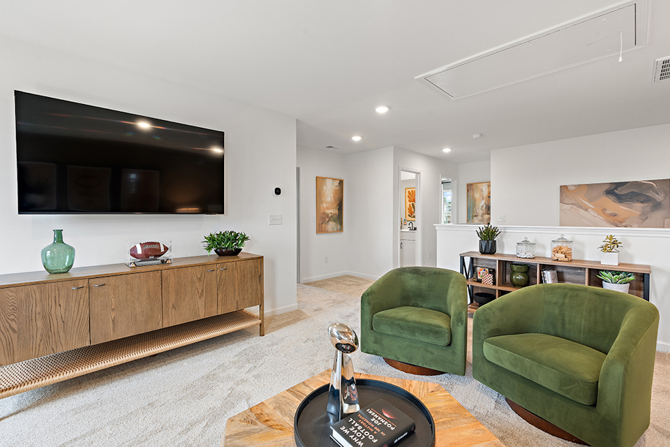 A living room with green chairs.