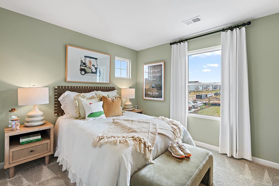 A bedroom with a large window.