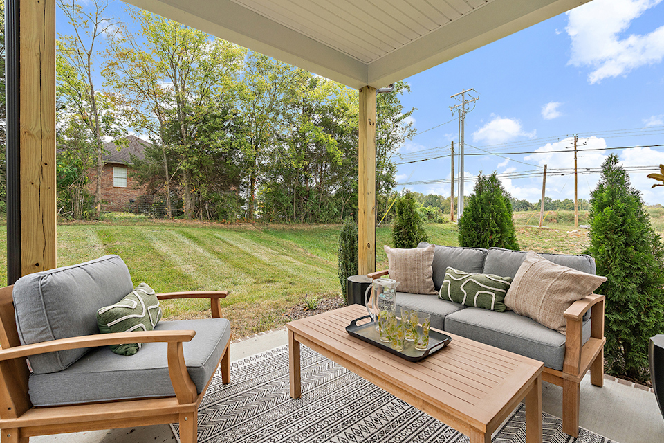A patio with a table and chairs.