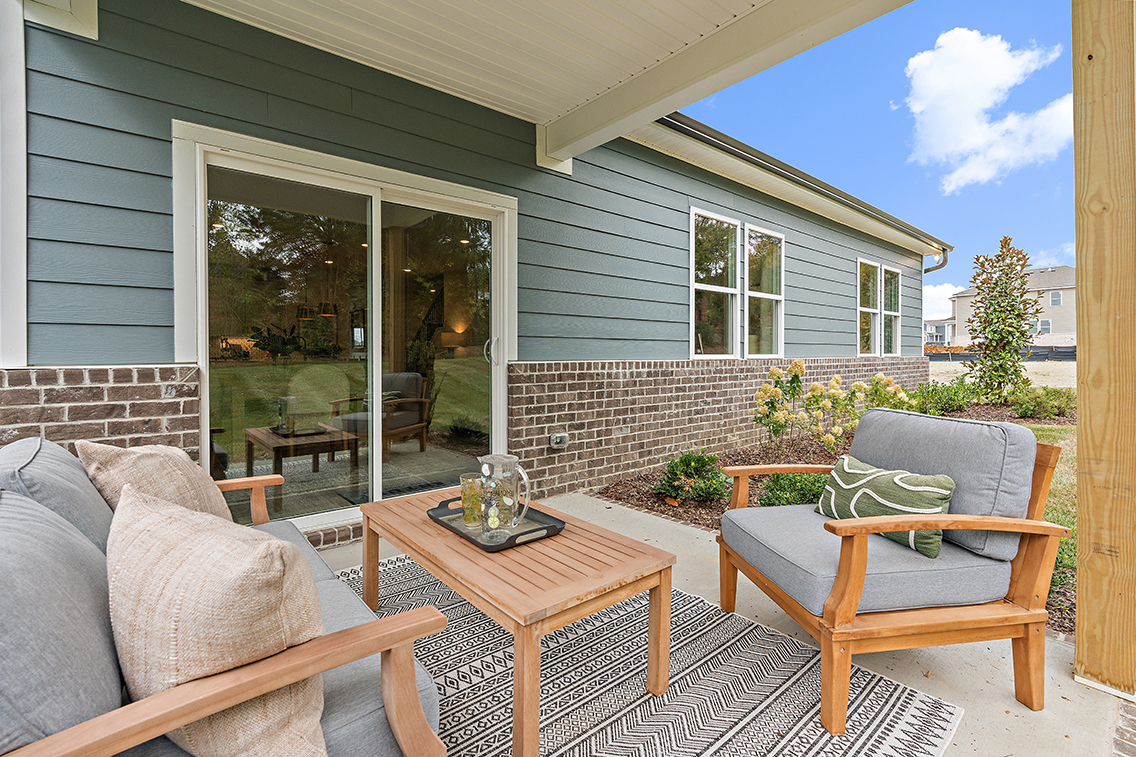 A patio with a table and chairs.