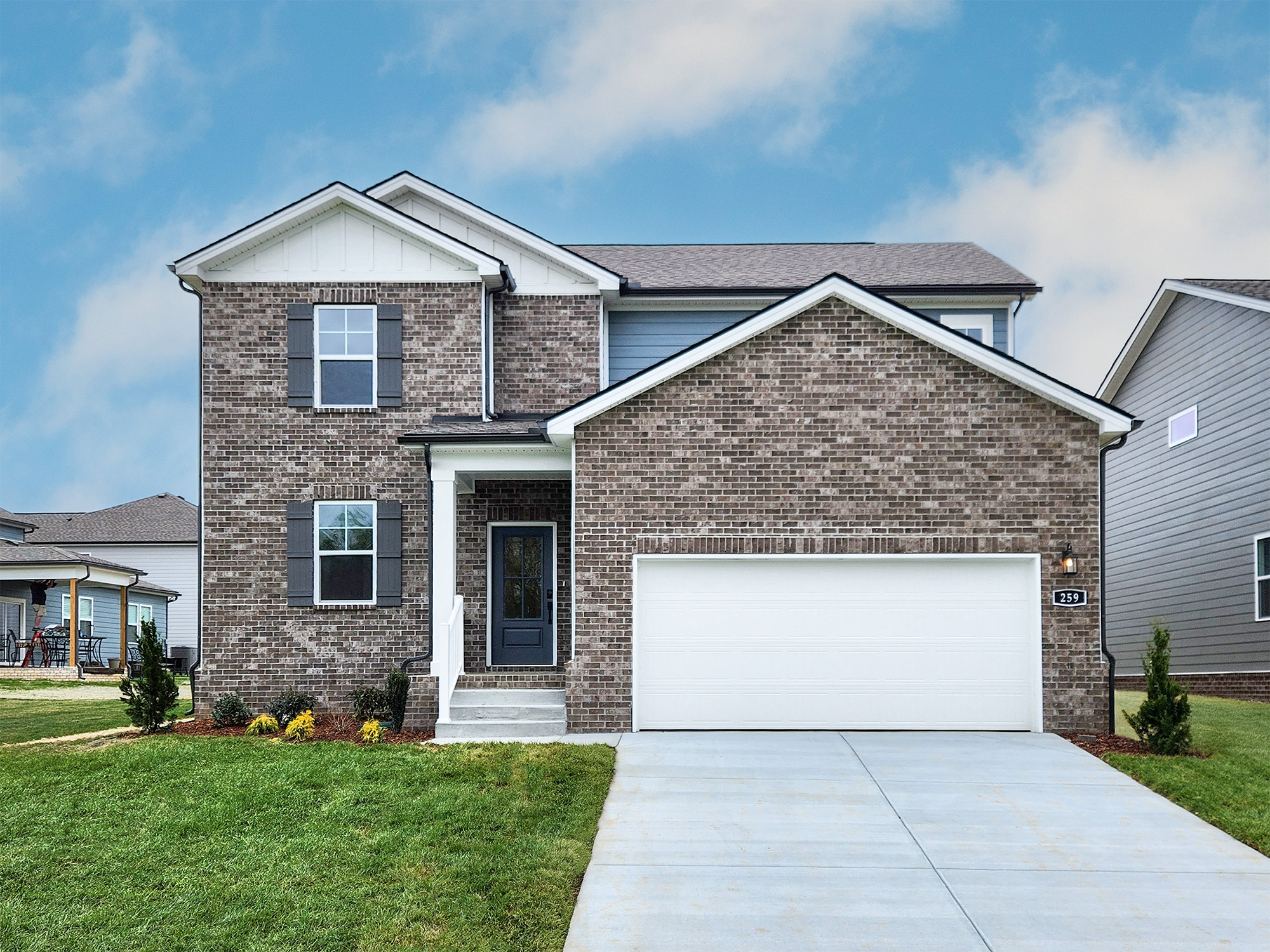 A brick house with a garage.