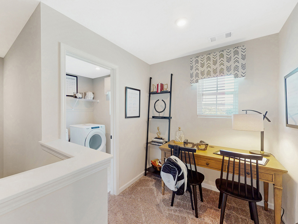 A bathroom with a sink and a bed.