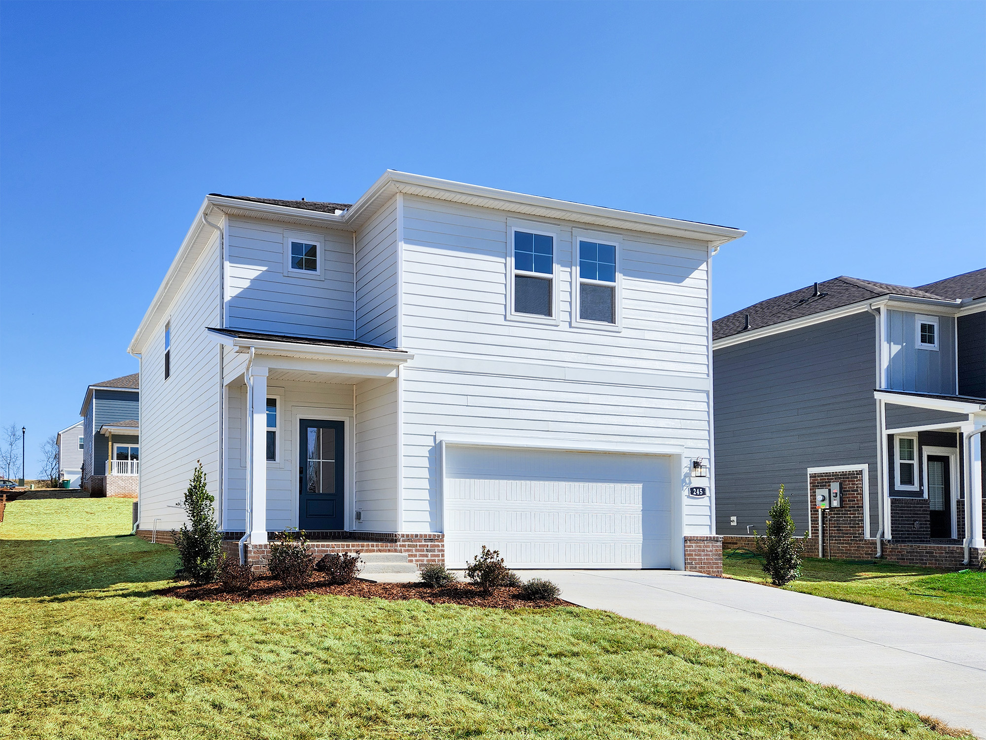 A white house with a garage.