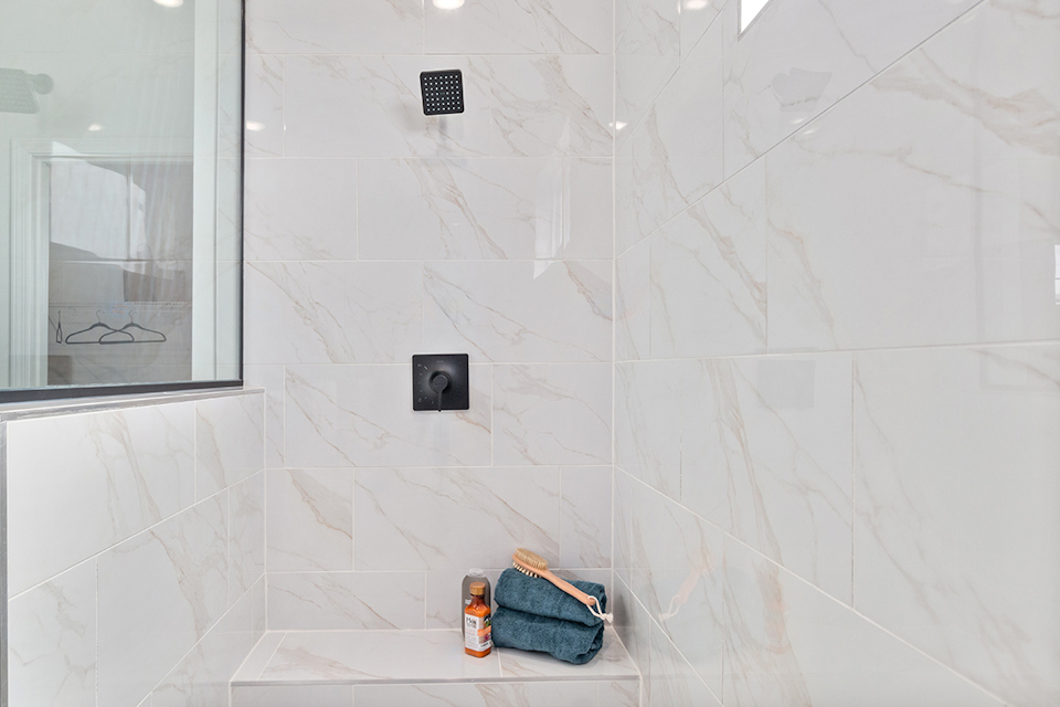 A bathroom with a tile wall.