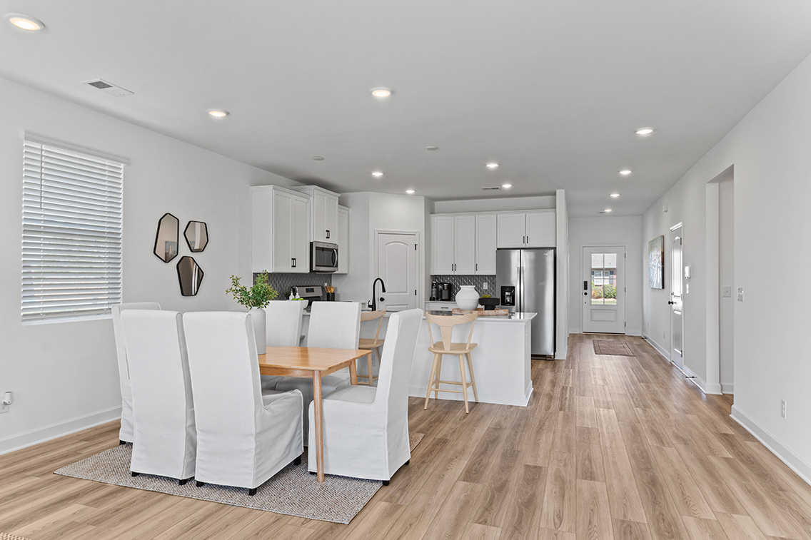 A kitchen with white furniture.