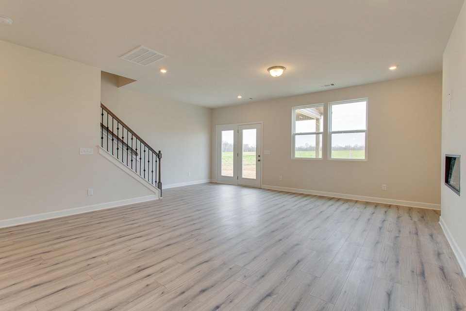 A room with a wood floor and a wood floor with a railing.