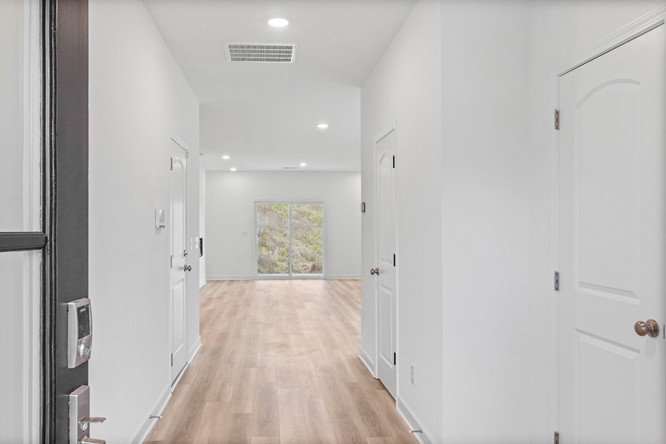 A hallway with white doors.