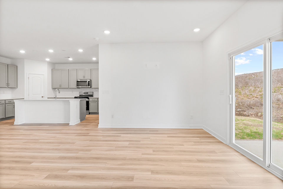 A kitchen with a wood floor.