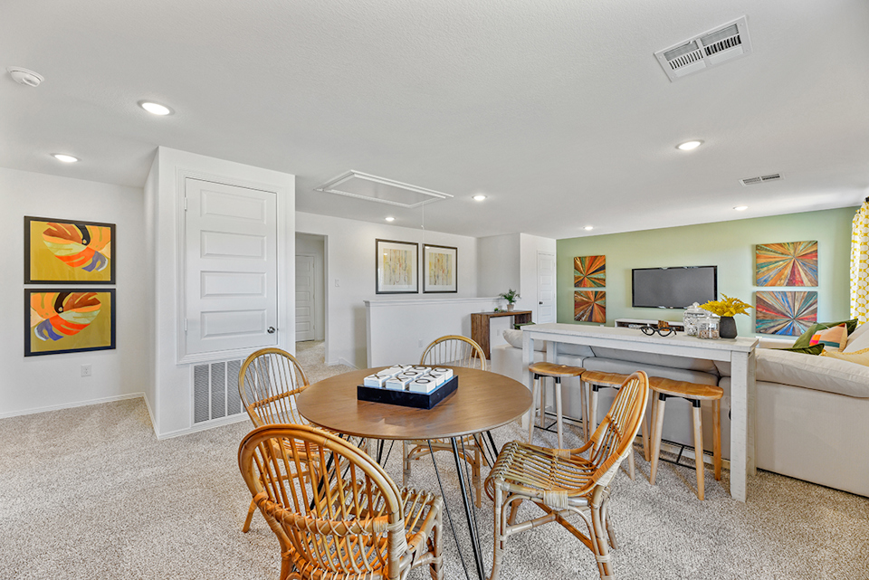 A room with a table and chairs.