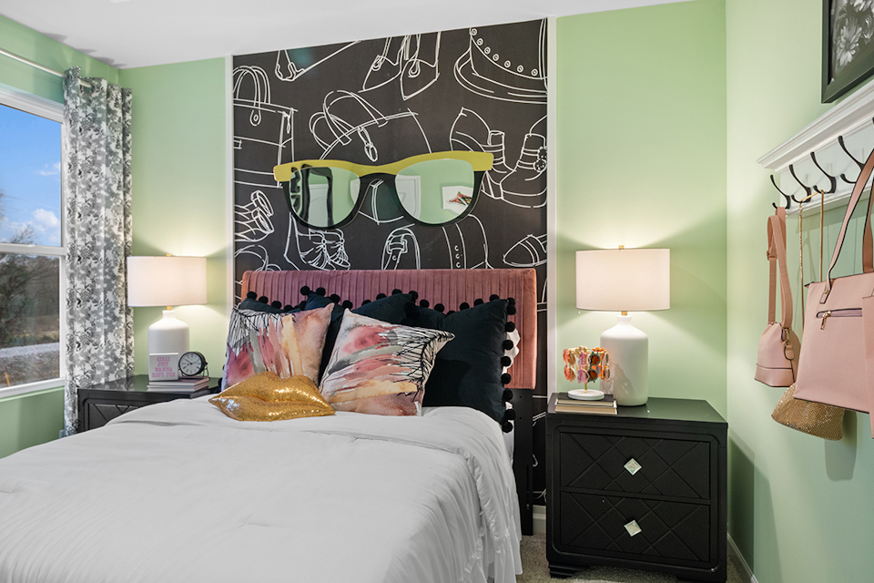 A bedroom with a large poster on the wall.