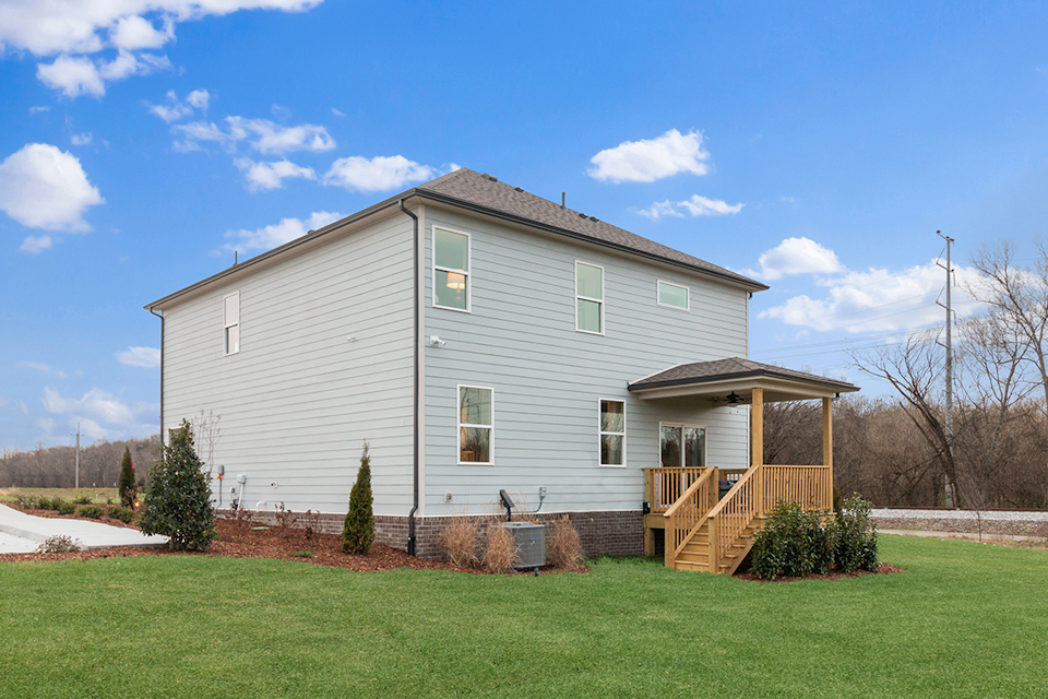A house with a yard and a fence.