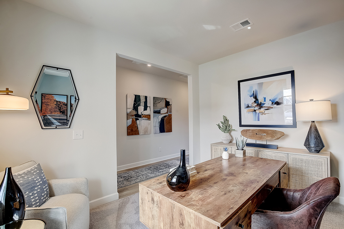 A living room with a table and chairs.