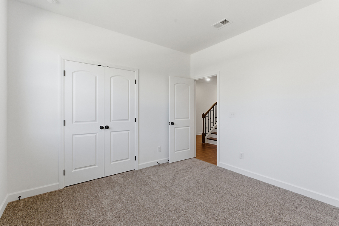 A hallway with white doors.