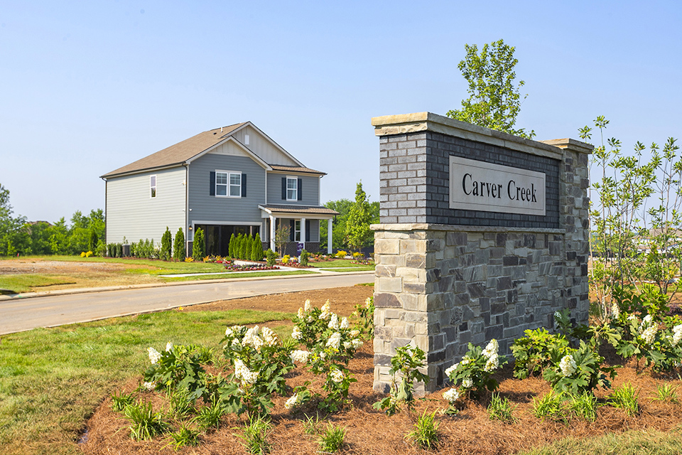 A house with a sign on the front.