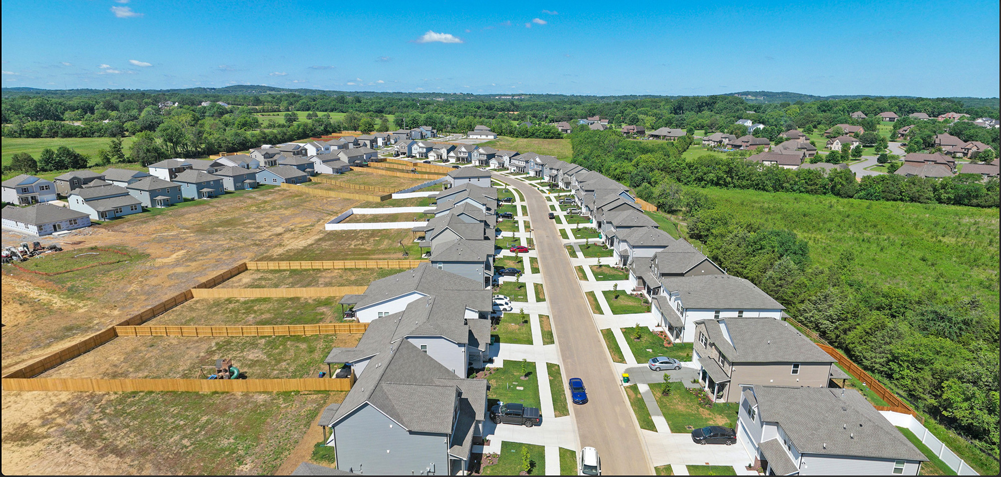 A large area with many buildings and trees in the background.