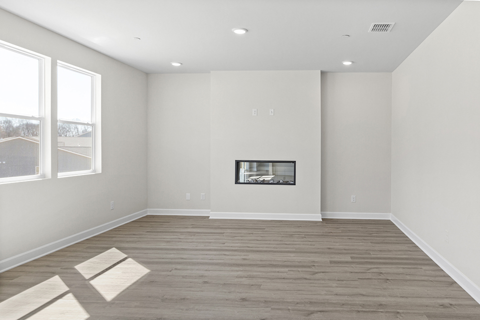 A room with a wood floor and a window with a picture on it.