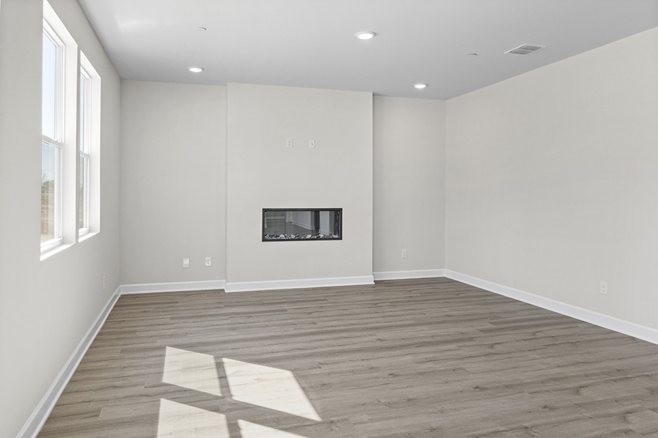 A room with a wood floor and white walls.