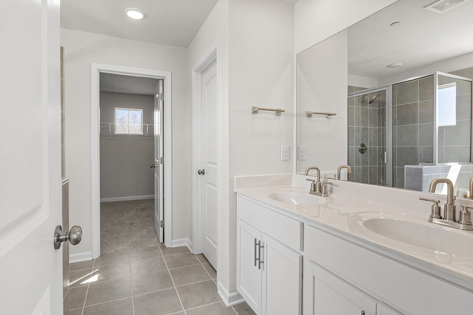 A bathroom with a large mirror.