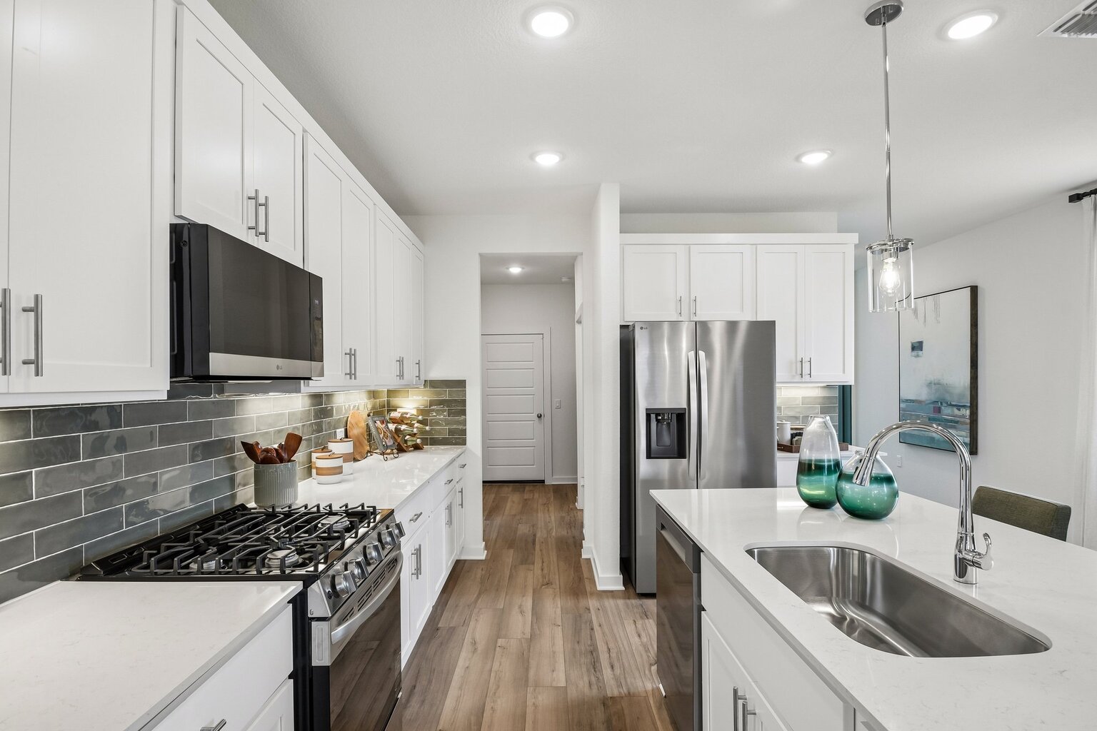 A kitchen with white cabinets.